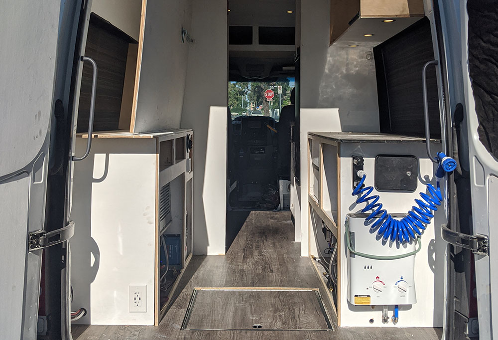 Custom camper van interior featuring professional plumbing and propane water heater installation by Vanpire Customs in Los Angeles, California. We ensure all gas and water systems are safe, watertight, and fully functional.