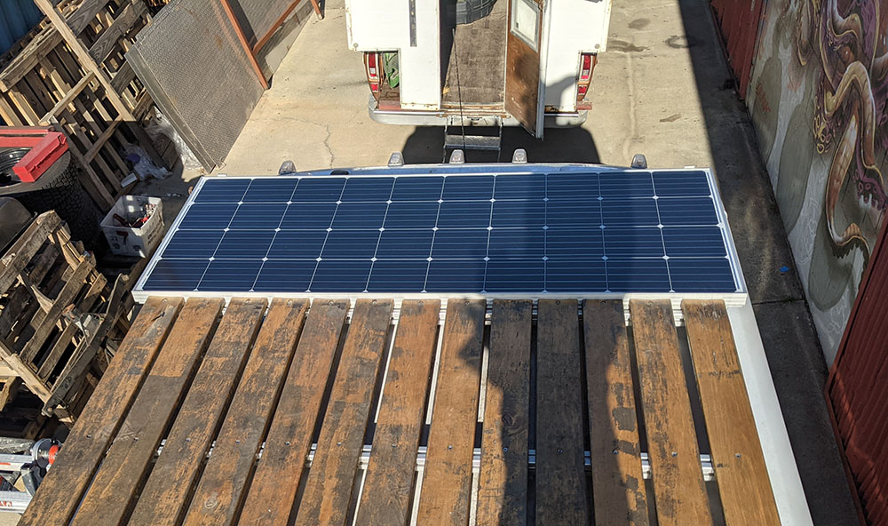 Professional solar panel installation on a custom roof rack for a camper van, executed by Vanpire Customs in Los Angeles, California, for reliable off-grid power."
