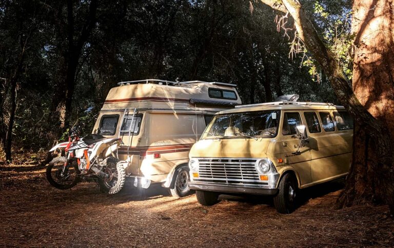 Vintage camper van parked in a forest setting, highlighting the freedom of the open road that Vanpire Customs supports with professional mobile RV repair services in Los Angeles, California