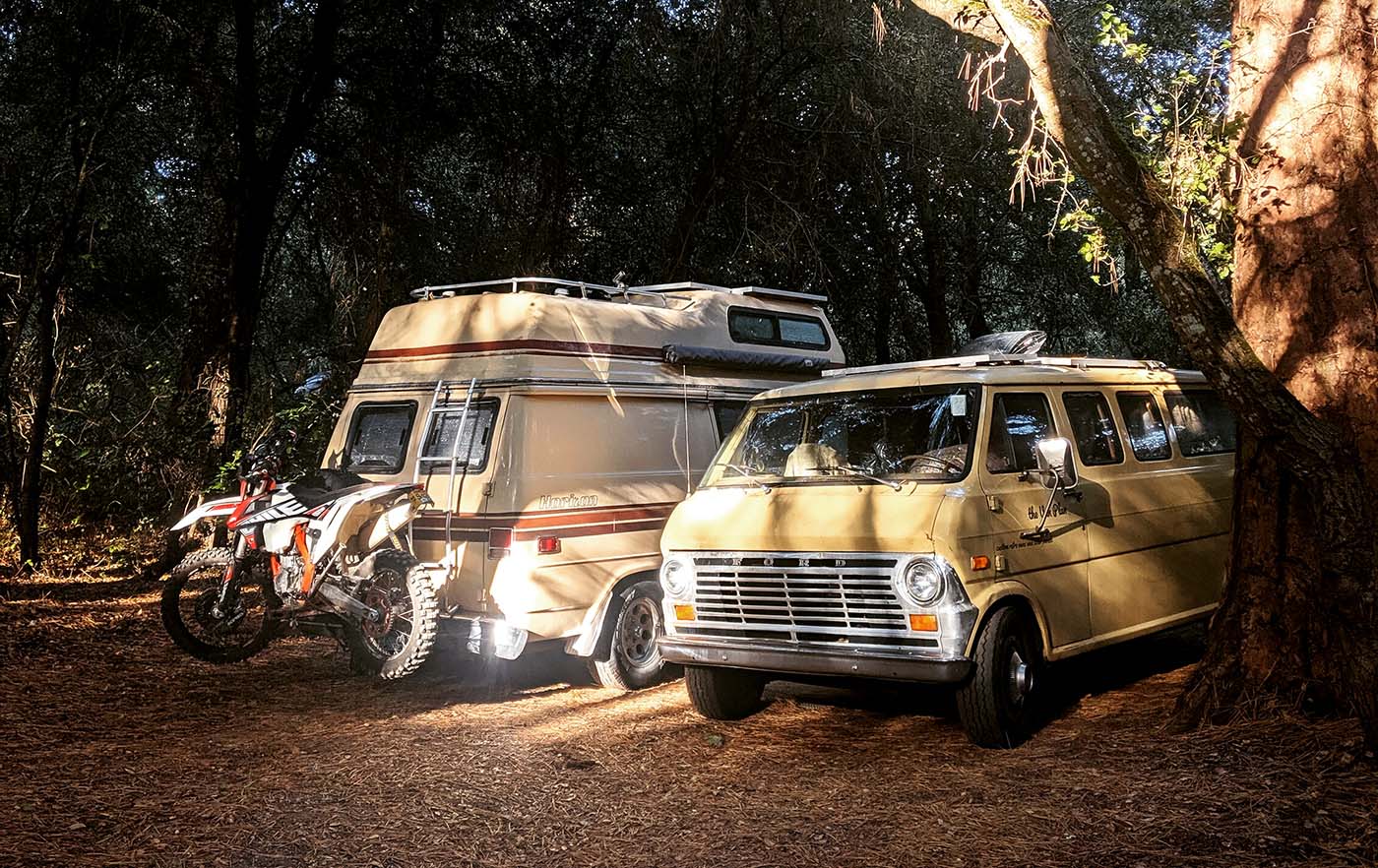 Vintage camper van parked in a forest setting, highlighting the freedom of the open road that Vanpire Customs supports with professional mobile RV repair services in Los Angeles, California