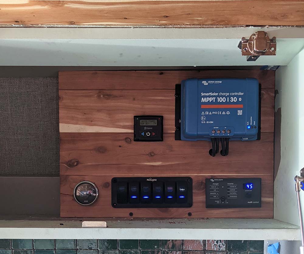 Professional camper van electrical system installation and repair by Vanpire Vans, featuring high-quality Victron Energy MPPT charge controllers and custom switch panels for off-grid power