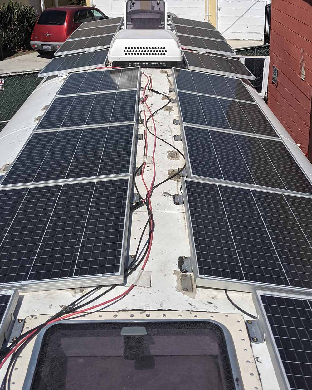 Detailed view of a professional solar panel installation on the roof of a custom camper van, built for off-grid power by Vanpire Vans in Los Angeles.